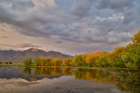 USA, Montana, Allentown. Evening light of Mission Mountains reflected in small pond. Art Print
